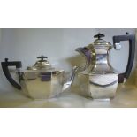 A silver teapot of panelled, elongated o