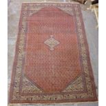 A Senneh rug with a central medallion an