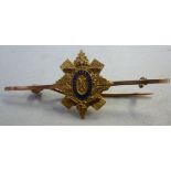 A 9ct gold bar brooch, mounted with the