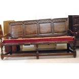 An early 18thC oak settle, having a foli