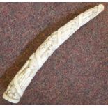 An early 20thC short ivory tusk, carved
