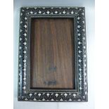 An Indian cushion moulded ebony picture