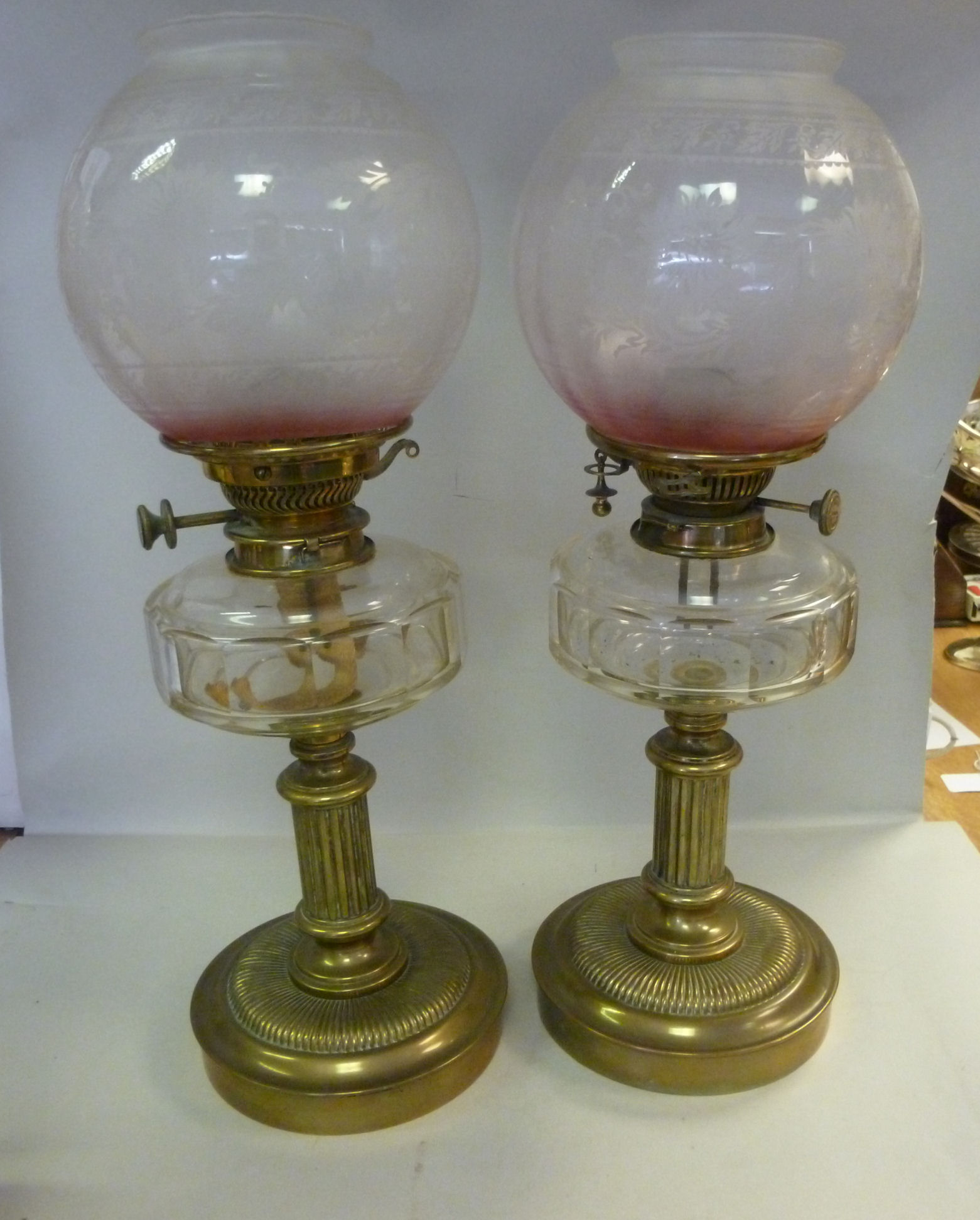 A pair of late Victorian brass oil lamps