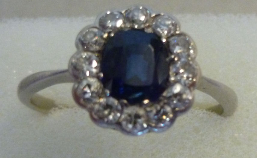 A platinum cluster ring, set with a cent