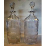 A pair of Edwardian clear glass decanter