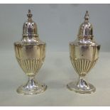 A pair of Edwardian silver pepper pots o