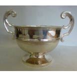 A silver trophy bowl, having a rolled li