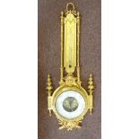A late 19thC gilt brass barometer, ornat