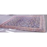 A Persian carpet with entwined flowers a