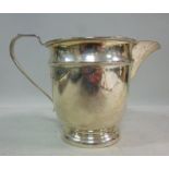 A silver cream jug, having a flared lip