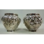 A pair of Asian silver coloured metal po