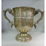 A silver twin handled trophy cup, on a s