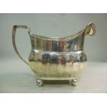 A George III silver cream jug of wide, d