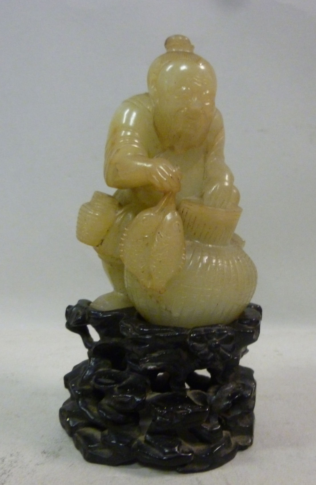 An early 20thC Chinese jade figure, a fi