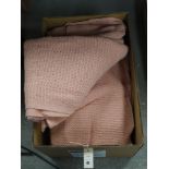 A collection of pink woollen blankets.