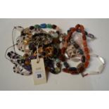 A quantity of costume jewellery, including: stone necklaces.