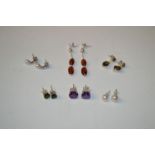 A pair of amber earrings; a pair of amethyst stud earrings; a pair of cultured pearl earrings; a