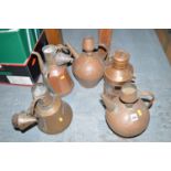 Four Middle Eastern copper teapots; together with a copper lantern.