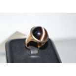 A banded agate ring, the single banded agate cabochon collet set on a 9ct.