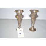 A pair of silver vases, by William Comyns, London 1902, of hammered design to tapering stem,
