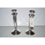 A pair of silver candlesticks, by Adie Bros., Birmingham 1953, of tapering form with weighted bases.