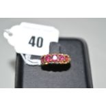 A five stone garnet ring, each of the graduated garnets in claw mount,