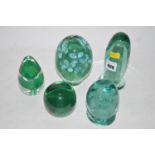 Four green glass Sunderland dumps; together with a Wedgwood paperweight.