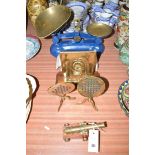 A set of Salters kitchen scales and weights; a pair of miniature brass tables and fireplace;