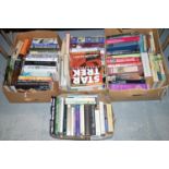 A quantity of hardback and paperback books, various subjects, in four boxes.