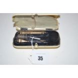A 19th Century ivory cased sewing set, with stained monogram to exterior, needle case,