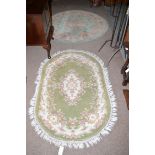 A circular Chinese rug; together with an oval Chinese style rug.