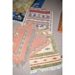Five flat woven rugs, three matching, all with geometric design.