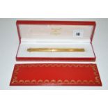 A Must de Cartier ballpoint pen in gilt metal case, the pocket clip engraved with initial,