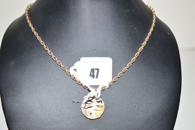 A diamond set 9ct. yellow gold bark pattern drop pendant, on twist link chain stamped '9ct', 18grms.