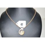 A diamond set 9ct. yellow gold bark pattern drop pendant, on twist link chain stamped '9ct', 18grms.