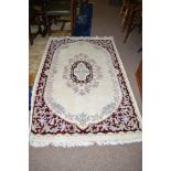 A Indian rug, decorated with floral designs to ivory ground. 6x4ft.