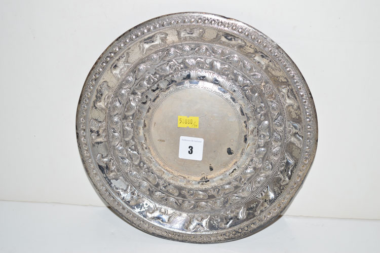 An Indian white metal circular salver, decorated with elephants, horses, lions, birds and scrolls.