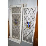 An early 20th Century large window frame containing three leaded glass panels,