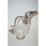 A moulded glass claret jug, with plated mounts in the form of a duck.