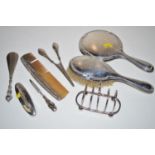 A silver backed dressing table hand mirror; a hair brush; glove stretchers; nail buffer;