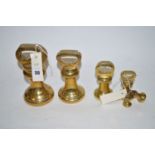 A set of six graduating brass bell weights.