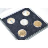 A collection of gilt and enamel silver commemorative coins, from 'The Treasures of Tutankhamun',