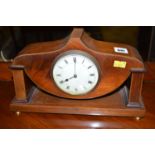 An Edwardian mantel clock in shaped and inlaid mahogany case.
