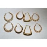 Four pairs of gold and yellow metal hoop earrings.