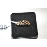 An openwork 9ct. gold ring set three small diamonds, ring size O.