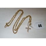 A white stone set 9ct. yellow gold crucifix pendant, on 9ct. gold chain, 8.5grms gross.