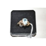 A blue topaz ring, the pear cut blue topaz set between openwork shoulders, 9ct.