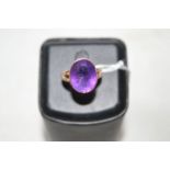 An amethyst ring, the oval facet cut amethyst collet set in rose gold mount, ring size R.