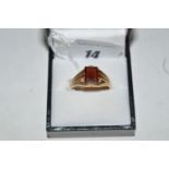 A garnet ring, the canted rectangular facet cut garnet claw set to fluted mount, on 9ct.