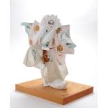 A Japanese porcelain Hakata doll "lion dancer", raised on wooden base,